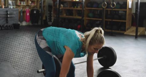 Female Athlete Lifting Barbell in Gym for Strength Training