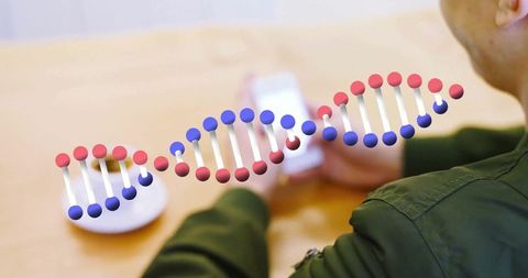 Man holding smartphone with digital dna helix concept