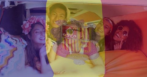 Laughing friends relaxing in retro camper with andorra flag overlay for festival roadtrip