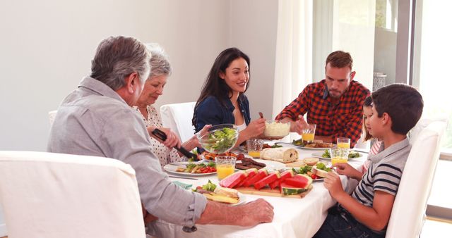 Multigenerational Family Sharing Meal at Home Around Dining Table - Download Free Stock Images Pikwizard.com