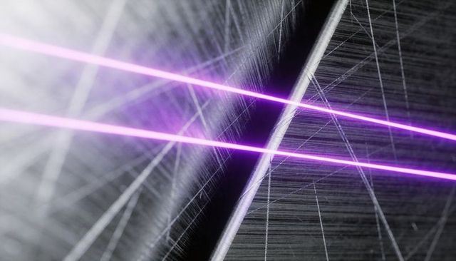 Shining parallel violet laser beams crossing scratched metal surface with halo effects