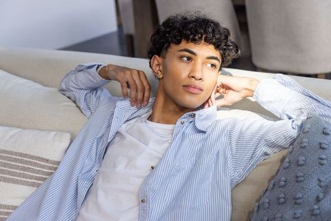 Young Man Relaxing on a Contemporary Living Room Sofa