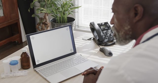 Doctor Conducting Remote Consultation Over Laptop in Office - Download Free Stock Images Pikwizard.com