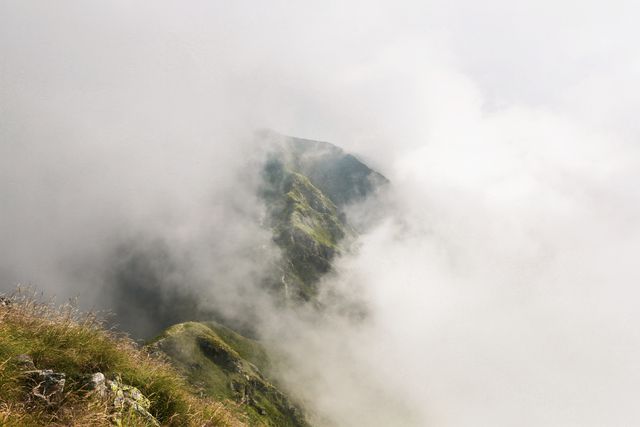Misty Mountain View With Lush Green Cliffs Emerging From Clouds - Download Free Stock Photos Pikwizard.com