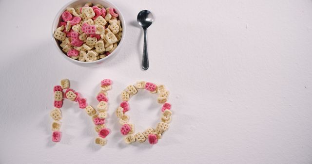 Cereal Bowl with Spoon and LAID OUT Crunchy O's Forming the Word 'NO' on White Background - Download Free Stock Images Pikwizard.com