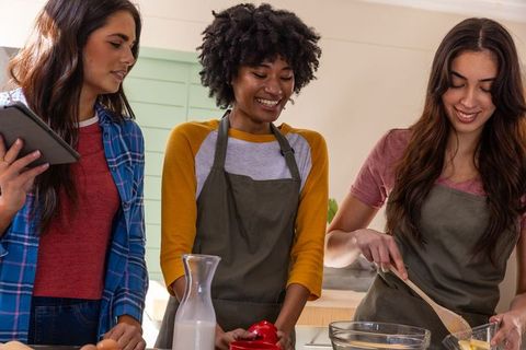 Diverse Female Friends Baking Together at Kitchen Island