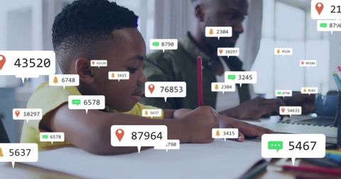Boy focusing on homework with augmented learning overlays and mentor using laptop