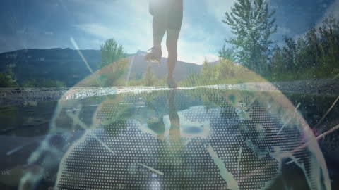 Woman Jumping in Puddle with Digital Globe Overlay in Nature