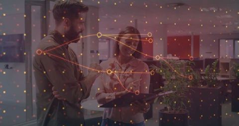 Colleagues Collaborating on Digital Project with Data Overlay