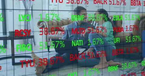 Couple Using Laptop with Stock Market Data Overlay
