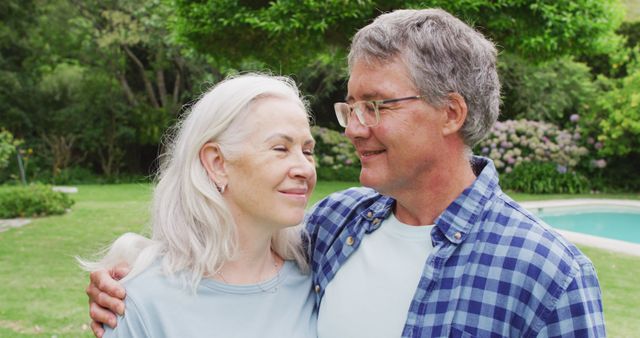 Image of caucasian senior couple embracing in garden. retirement lifestyle, relationship and spending free time outdoors.