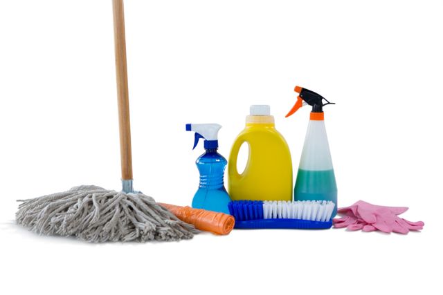 Mop by cleaning equipment against white background