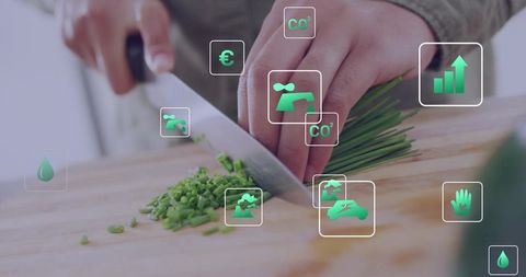 Chopping chives with chef knife and ar sustainability icons showing eco metrics, eco kitchen overlay