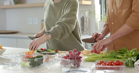 Couple Chopping Fresh Ingredients on Modern Kitchen Island