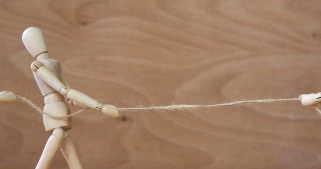 Wooden Mannequin Engaged in Tug of War with Rope - Download Free Stock Images Pikwizard.com