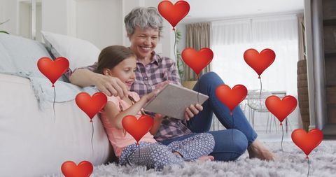 Grandmother and Granddaughter Sharing Digital Moments Surrounded by Love