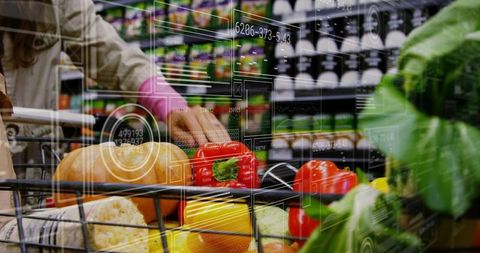Shopper grasping red bell pepper in smart grocery cart with augmented reality data overlay