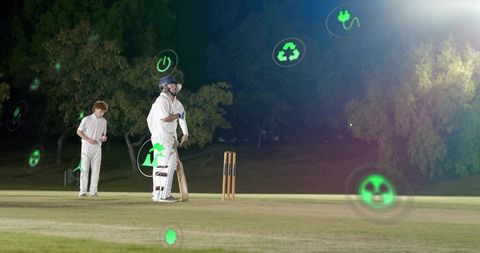 Night cricket batsman under floodlights with floating green eco and energy icons