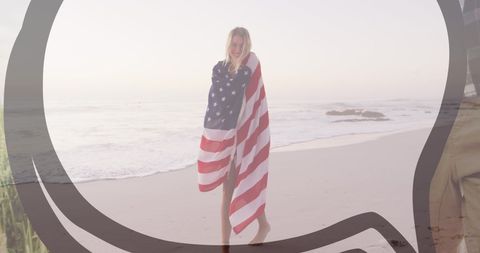 Young Woman Enjoying Beach Wrapped in American Flag