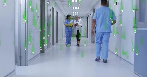 Healthcare team walking hospital corridor with digital data overlay and tablet