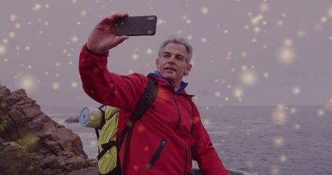 Senior Adventurer Poses for Selfie on Rocky Coastal Hike