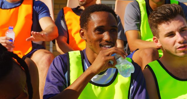 Athletic teammates hydrating during outdoor sports practice - Download Free Stock Images Pikwizard.com