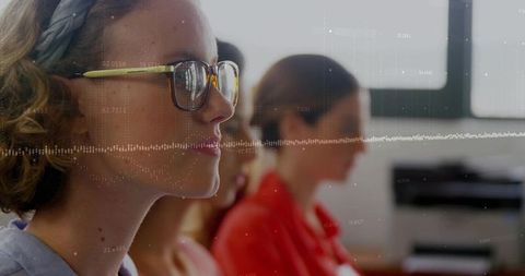 Focusing young woman wearing glasses and braided headband in bright classroom workshop
