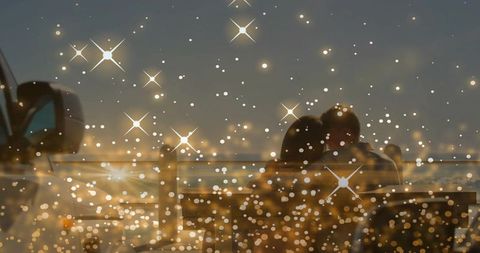 Couple watching dusk harbor with bokeh lights romantic silhouette and sparkle