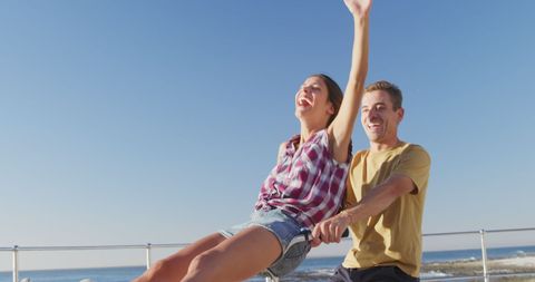 Joyful Couple Bicycling by the Seaside