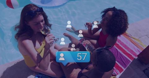 Women enjoying wine by pool representing relaxation and friendship