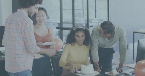 Office team celebrating birthday with colleague cutting cake, coworkers smiling and sharing dessert
