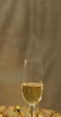 Single Glass of Champagne Against Warm Background - Download Free Stock Images Pikwizard.com