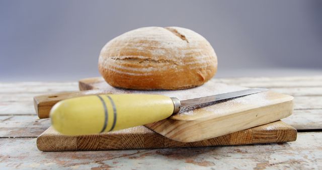 Freshly Baked Round Bread and Knife on Wooden Cutting Board - Download Free Stock Images Pikwizard.com