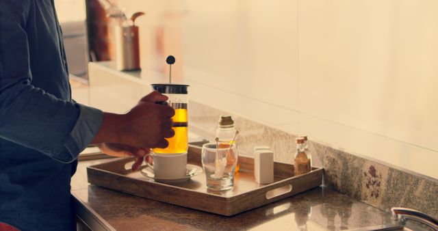 Person Brewing Tea with French Press in Modern Kitchen - Download Free Stock Images Pikwizard.com