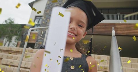 Joyous graduation through innocent eyes with diploma and confetti