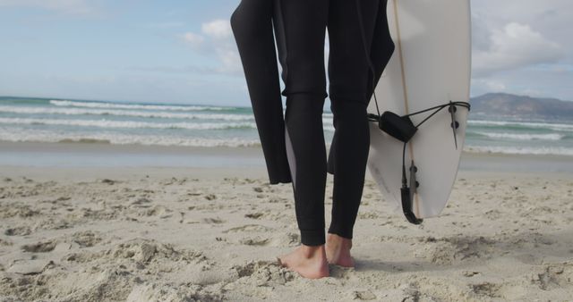 Surfer Holding Board on Sandy Beach Ready for Surfing - Download Free Stock Images Pikwizard.com