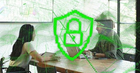 Colleagues Collaborating with Shield Overlay Symbolizing Cybersecurity and Network Protection