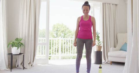 Yoga Practice in Bright Bedroom with Smiling Woman