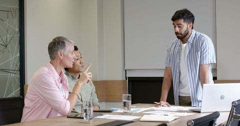 Diverse Team Collaborating at Conference Table in Modern Office