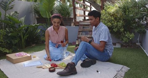 Happy Couple Enjoying Picnic in Sunlit Garden