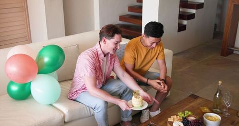 Couple enjoying relaxing conversation in living room celebration