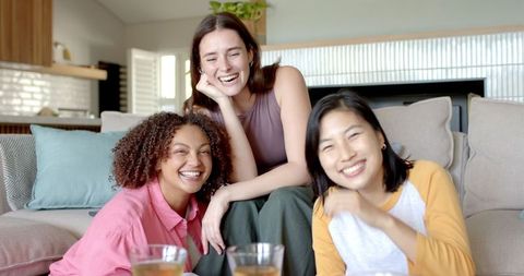 Diverse Friends Laughing Together in Modern Living Room