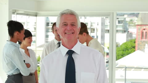 Smiling Businessman Leading Diverse Office Meeting