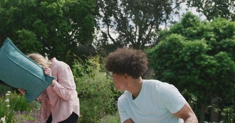 Happy Couple Playing in Lush Green Garden