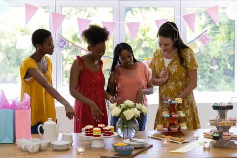 Diverse Women Hosting Joyful Baby Shower Brimming with Cupcakes