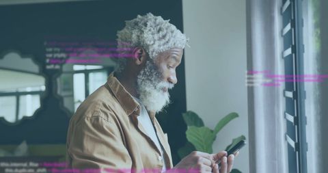 Senior Businessman Engaging with Smartphone in Modern Workspace