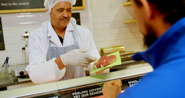 Butcher Presenting Fresh Meat to Customer at Market - Download Free Stock Images Pikwizard.com