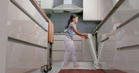 Young Girl Loading Dishwasher in Modern Kitchen - Download Free Stock Images Pikwizard.com