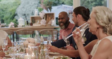 Friends Celebrating with Champagne at Outdoor Wedding Reception