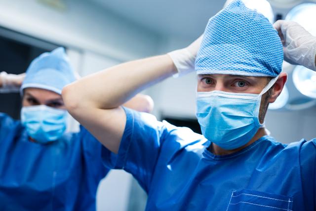 Portrait of surgeon wearing mask in operation room at hospital